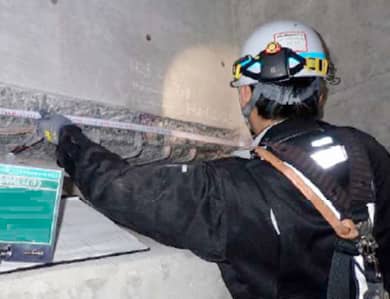 橋梁を更新するために損傷範囲を測定する様子